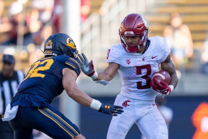 October 2, 2021; Berkeley, California, USA; Washington State Cougars running back Deon McIntosh (3) runs the football against California Golden Bears safety Daniel Scott (32) during the third quarter at FTX Field at California Memorial Stadium. Mandatory Credit: Kyle Terada-USA TODAY Sports